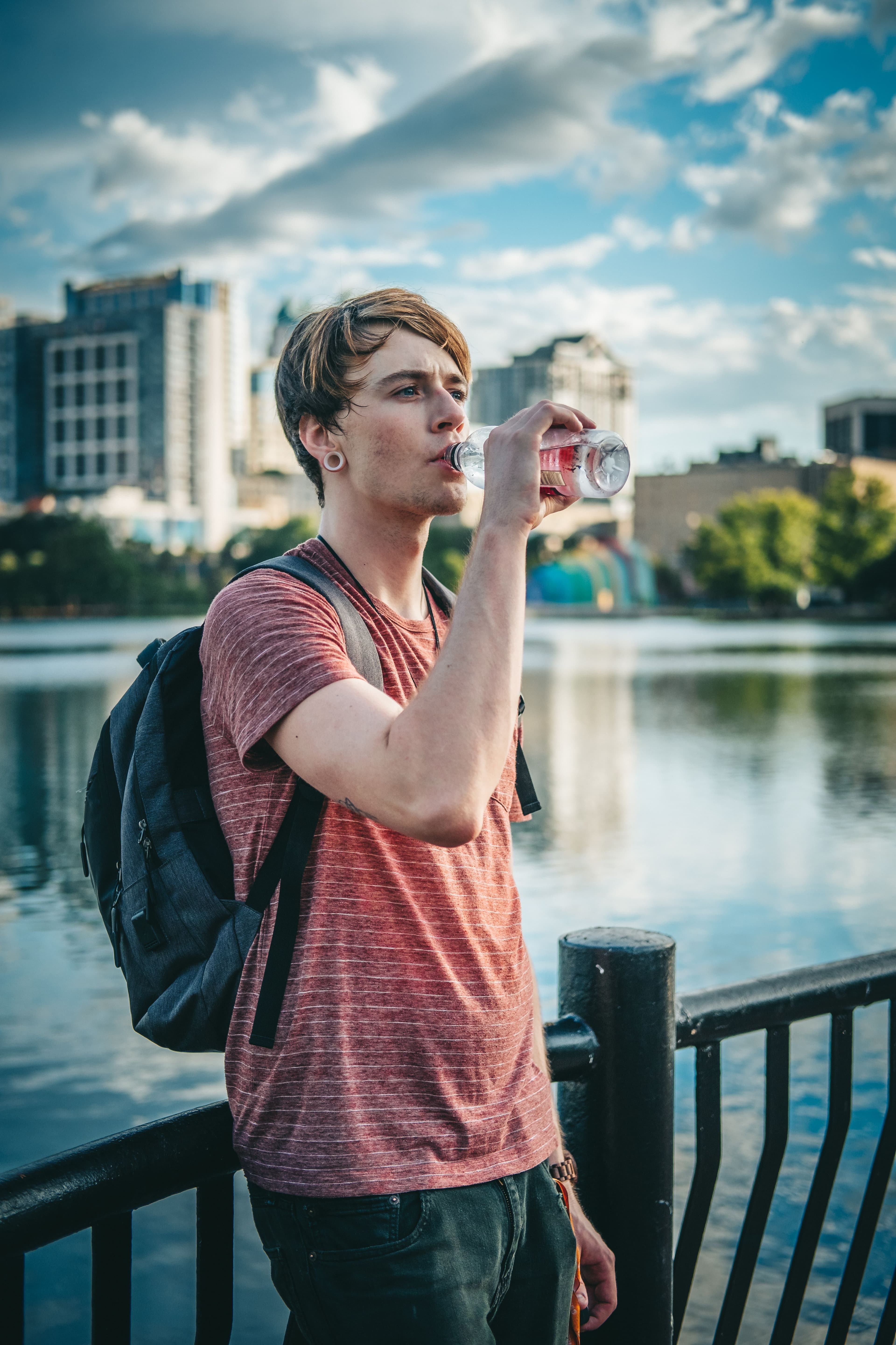 A person drinking water outdoors