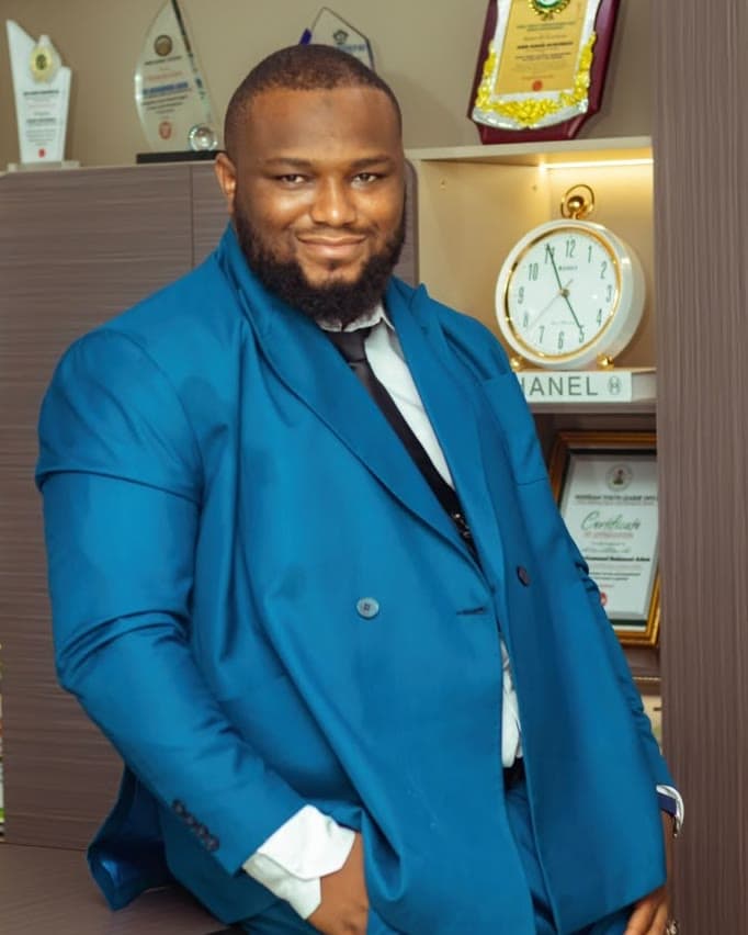 Adam Muhammed Bedemasi, founder of LAYLIFE, smiling in a blue suit
